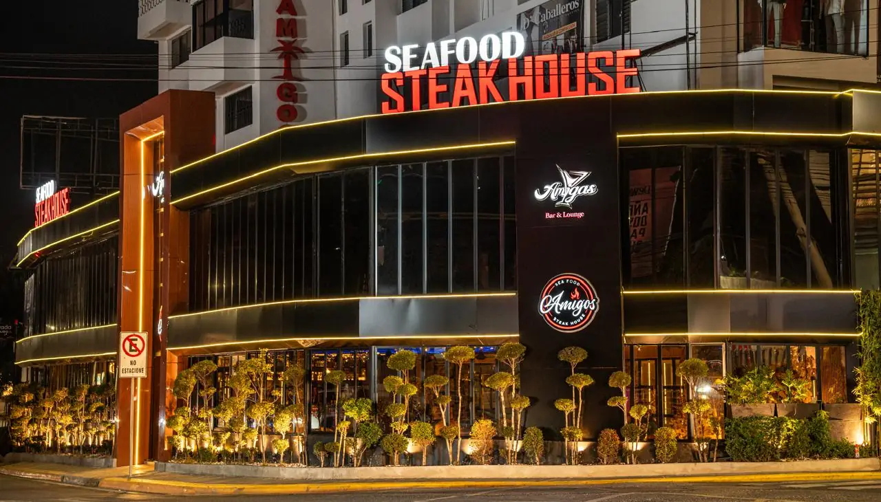 Illuminated facade of Amigos Seafood & Steak House in Santiago