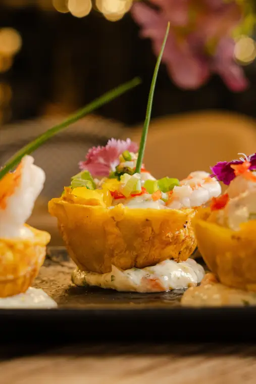 Plantain mofonguitos filled with shrimp and edible flowers